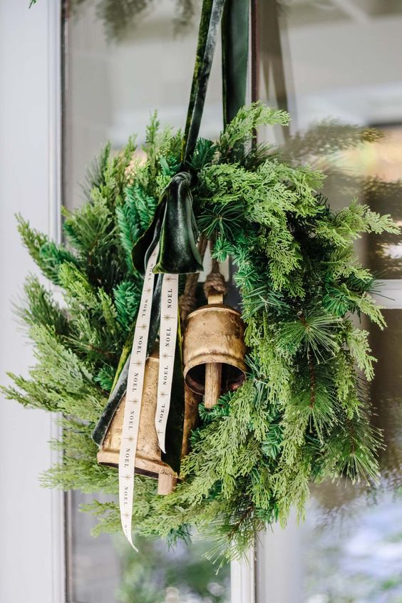 festive minimal holiday decor wreath with mixed greens and bells
